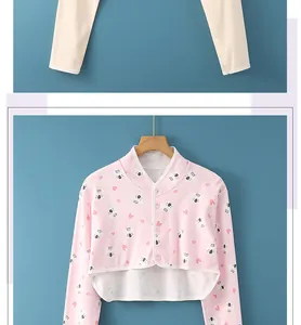 Close-up of baby pajamas set featuring pink koala print cardigan and beige trousers