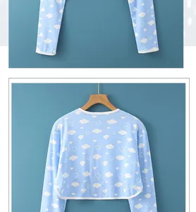 Close-up of light blue cotton shoulder shrug with white clouds and premium piping
