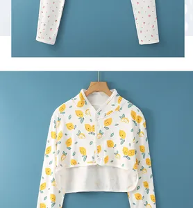 Detail of baby cotton cardigan featuring bright lemon prints and white buttons