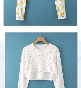 Close-up of cotton shoulder wrap with strawberry pattern and white buttons detailing