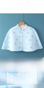 Macro detail of blue quilted cotton shoulder wrap with whale pattern and front buttons