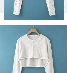 Detail view of cotton grey short cardigan with round neck and wooden hanger display