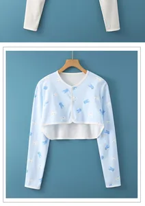 Detail of light blue cotton baby shoulder warmer featuring cute whale print patterns