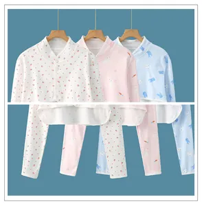 Detailed view of three patterns for baby cotton pajamas including strawberry and rabbit prints
