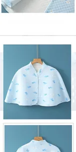 Detailed view of blue quilted cotton shoulder wrap with cute dolphin pattern and wood hanger