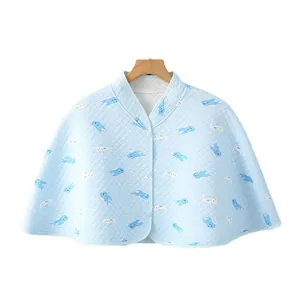 Quilted light blue cotton shoulder cape with whale prints and snap buttons for babies