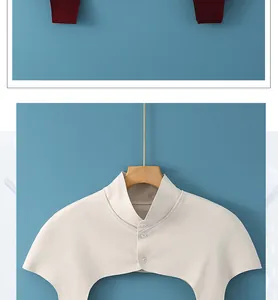Detail of knitted neck protector featuring three decorative buttons in wine and beige