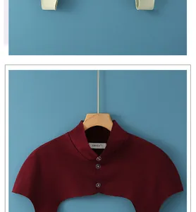 Close-up of burgundy high-neck shoulder warmer with three buttons and soft fleece texture