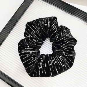 Detail of black velvet scrunchie with sparkling silver rhinestones on a display tray