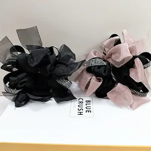 Detailed view of elegant oversized bow scrunchies with satin organza and rhinestone trim
