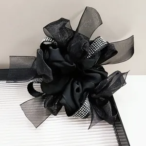 Detail of oversized black tulle scrunchie with sparkling silver rhinestone trim details