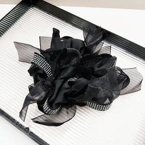 Elegant black organza scrunchie with silver rhinestones for stylish messy bun hairstyles