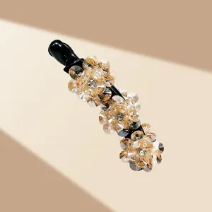 Détail du clip banane avec fleurs en cristal champagne et perles élégantes