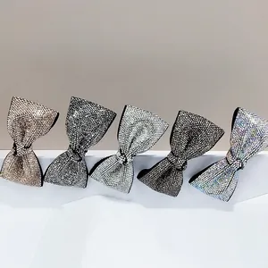 Sparkling rhinestone bow hair clips in 5 assorted colors on a neutral minimalist background