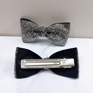 Elegant silver bow hair clip with sparkling rhinestones and metal duckbill clip