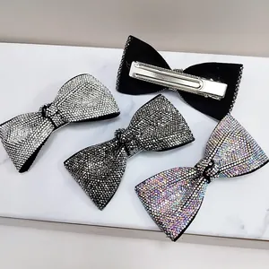 Set of four bow-shaped hair clips with sparkling rhinestones and duckbill metal backing