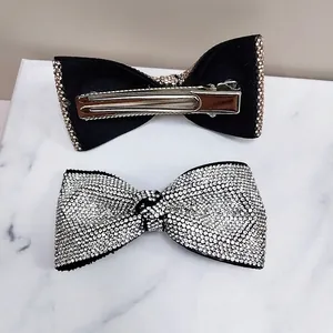 Close-up of bow hair clips with sparkling rhinestones and metal alligator clip backing