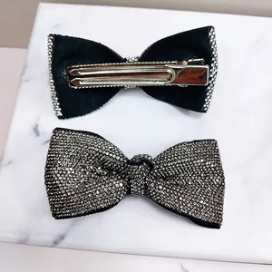 Macro detail of bow hair clips with silver rhinestones and metal alligator clasp