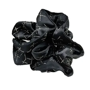 Elegant black satin oversized scrunchie featuring shimmering silver star patterns for women