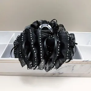 Detail of black cloud tulle hair claw clip with sparkling silver rhinestones