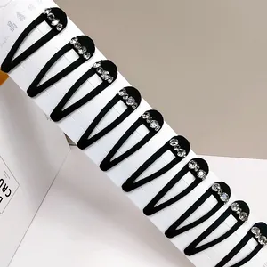 Detailed set of 10 black velvet snap clips with shiny rhinestones on display card