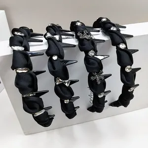 Set of four luxury black fabric headbands with elegant rhinestone embellishments