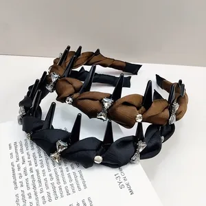 Detailed macro view of satin headbands with black teeth and sparkling rhinestones