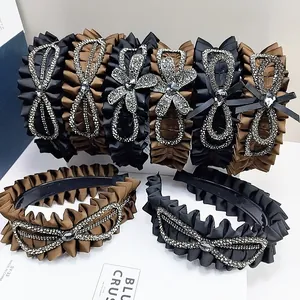 Elegant pleated rhinestone headbands set in black and coffee satin for a chic look