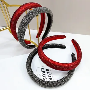 Detail of red and black rhinestone padded headbands on a golden stand with crystals