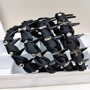 Detail of black fabric headbands featuring sparkling crystal bows and rhinestones