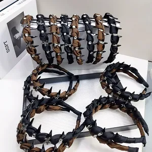 Detail of satin headbands with silver rhinestones and metal stars in black and brown