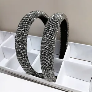 Detail of wide sparkling rhinestone headbands with silver crystals in a white display box