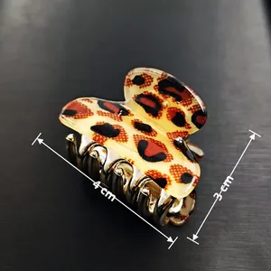 Leopard print hair claw clip with 4cm length and gold metal teeth on black background