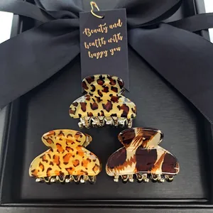 Three-piece leopard print hair claw clips set with gold metal teeth on black silk ribbon