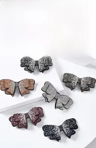 Macro detail of multi-color crystal rhinestone bow hair clips in various elegant finishes
