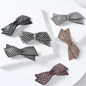 Sparkling rhinestone bow hair clips in six colors on white stone pedestals