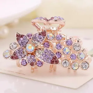 Elegant rose gold flower hair claw with purple rhinestones and crystal accents