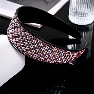 Sparkling pink rhinestone wide headband with anti-slip teeth shown on a dark reflective surface