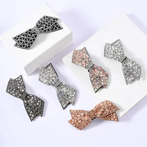 Detail view of multi-color double-layered bow hair clips with shimmering rhinestones