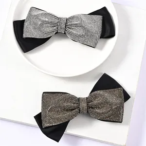Elegant satin bow hair clip with sparkling rhinestones in silver and bronze color