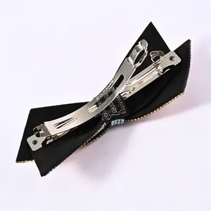 Detail of black double layer bow hair clip with rhinestones and metal spring clasp