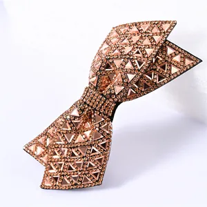 Detail of rose gold double bow hairpin featuring micro-set rhinestones and triangle crystals