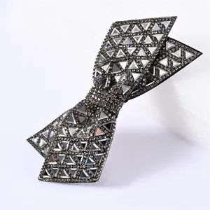 Detail of a large double-layer black bow hair clip with crystal rhinestones and mirror gems
