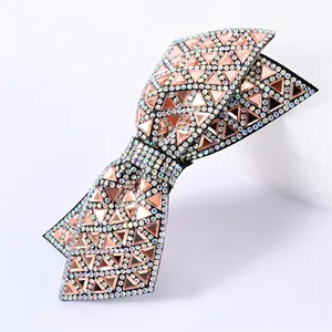 Close-up of double layer bow hair clip with pink crystal triangles and rhinestones