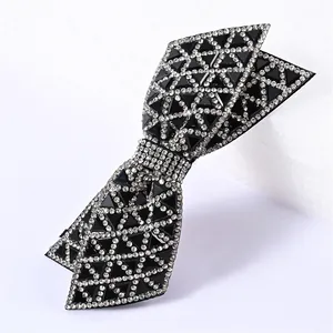 Macro shot of double-layered black bow hair clip with sparkling silver crystal rhinestones