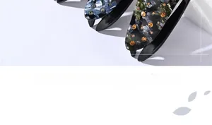 Detail of blue marble and dark floral acrylic hair claw clips with sparkling rhinestones
