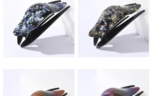 Detail showing marble resin duckbill hair clips with sparkling rhinestones and glitter