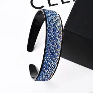 Detailed view of blue rhinestones on a vintage headband with non-slip inner teeth