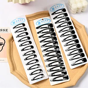 Tres paquetes de pinzas para el cabello negras tipo gota grandes en tarjetas blancas