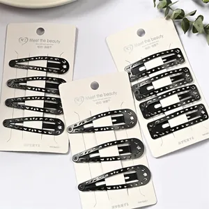 Detalle de pinzas para el cabello negras tipo gota con diseños huecos de flores y estrellas